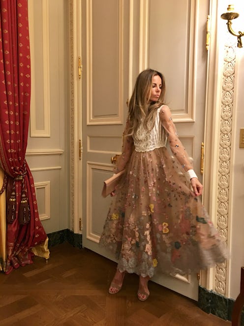 Erica Pelosini posing in a couture brown dress and white top