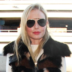 Kate Bosworth in sunglasses, wearing a white dress with a faux fur coat over top