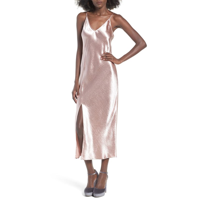 A model posing in a pink slip dress