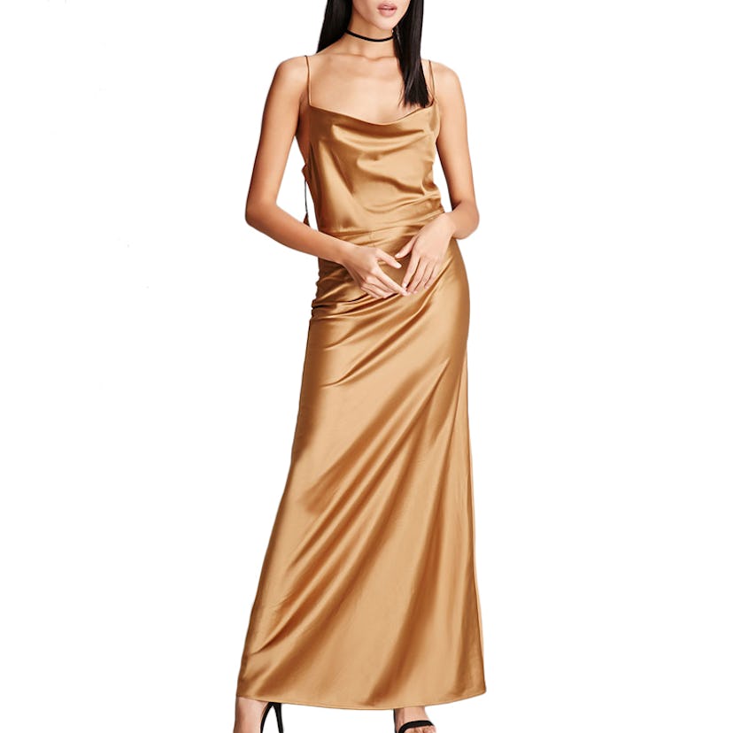 A model posing in a brown slip dress