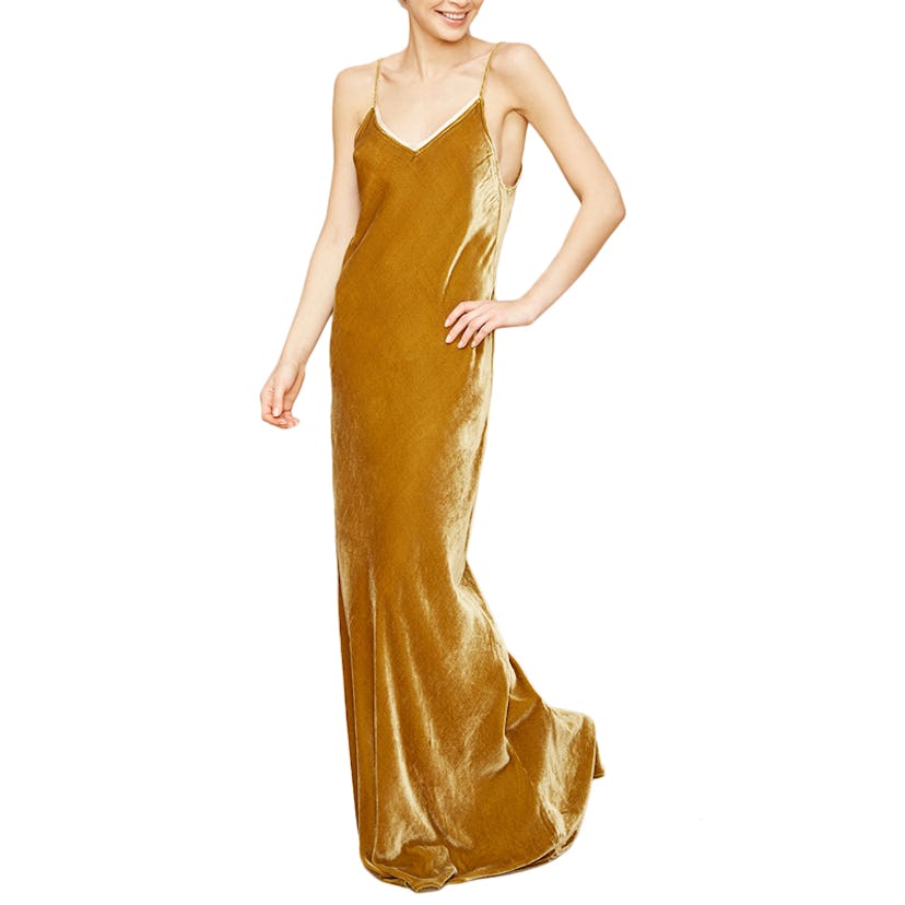 A model posing in a golden slip dress