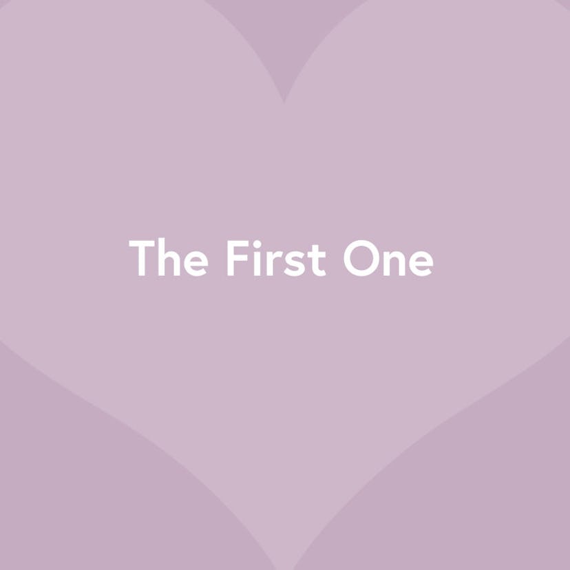 "The First One" text sign on a purple heart-shaped background 