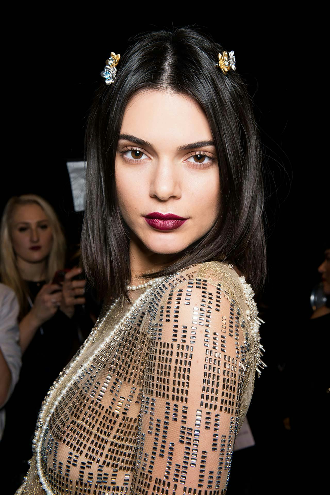 Kendall Jenner in this spring's must-have lip color mauve shade and a beige sequin dress