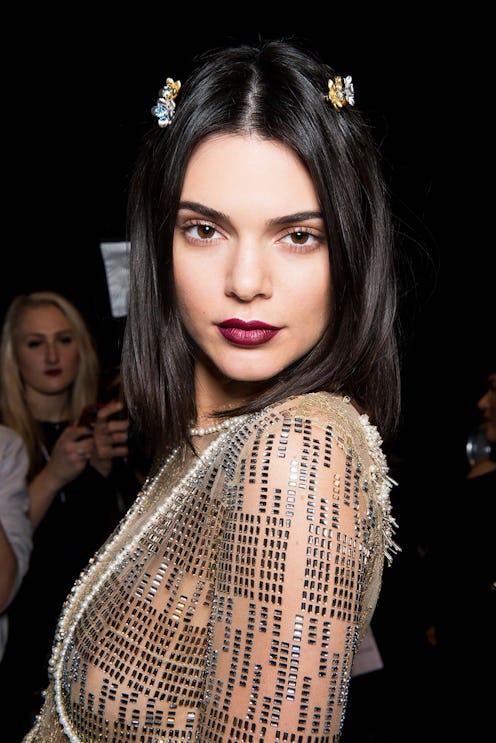 Kendall Jenner in this spring's must-have lip color mauve shade and a beige sequin dress