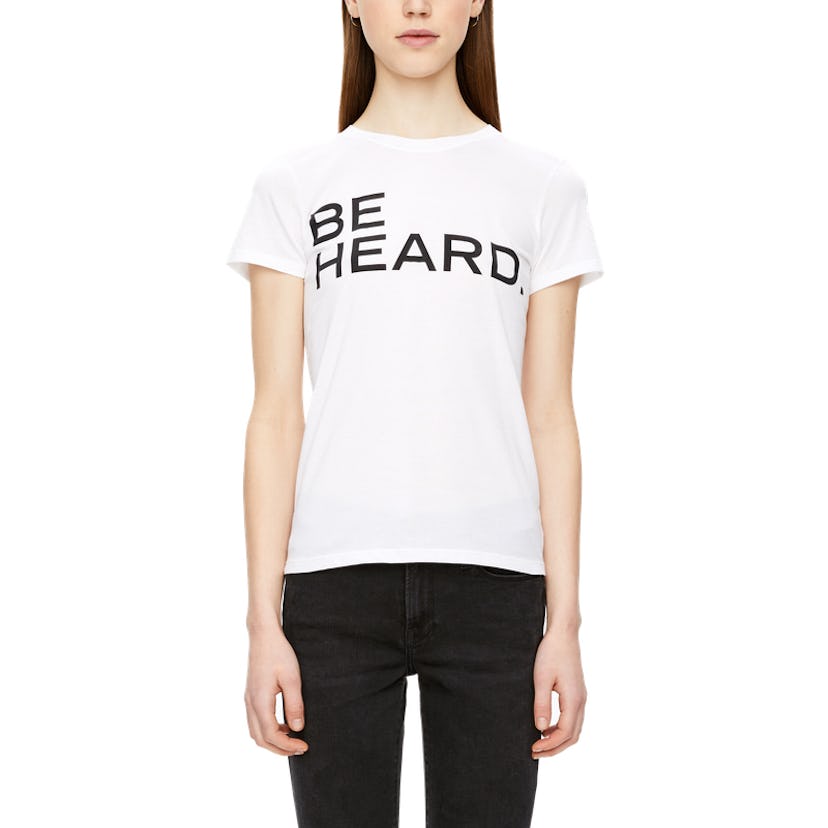 A girl posing in a white shirt with "be heard" text
