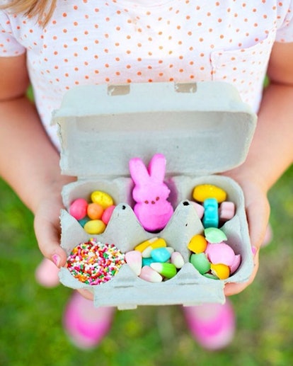 A kid holding a gift box filled with colorful candies