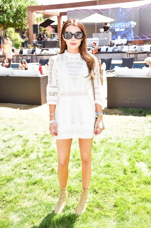 Emma Roberts posing in a white minidress at the Coachella 