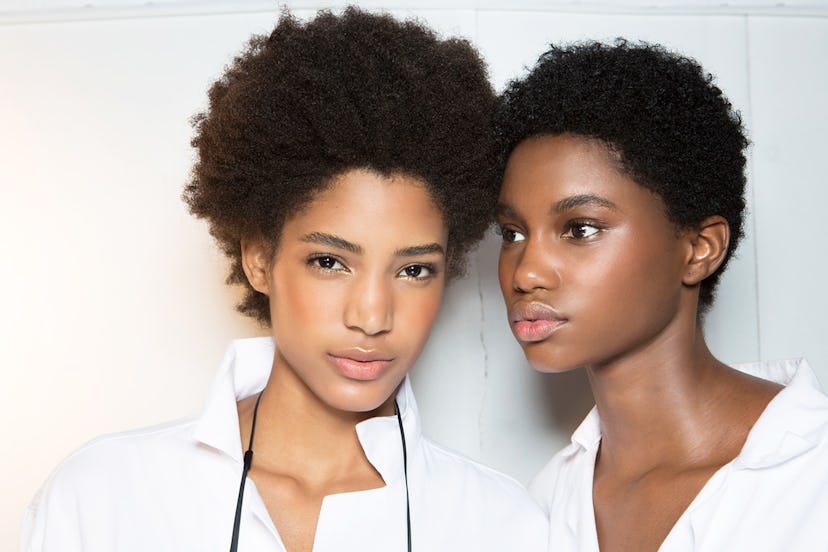 Two women with well-cared face skin posing for a photo