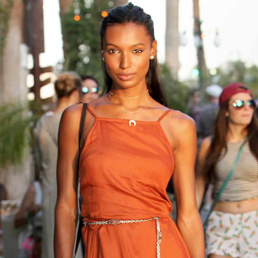 Victoria’s Secret angel, Jasmine Tookes in a orange outfit posing at coachella