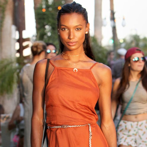 Victoria’s Secret angel, Jasmine Tookes in a orange outfit posing at coachella