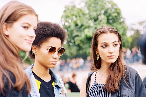 Three girls that hate sunscreen standing in a park