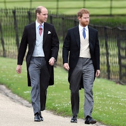 Prince William and Prince Harry walking down a road next to each other in formal wear