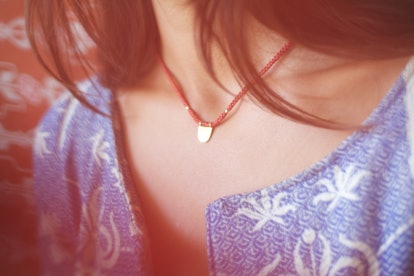Closeup of a woman wearing a red necklace