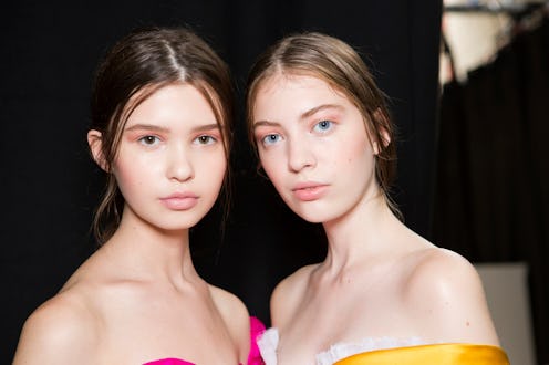 Two girls posing for a photo with their faces cleaned with a cleanser