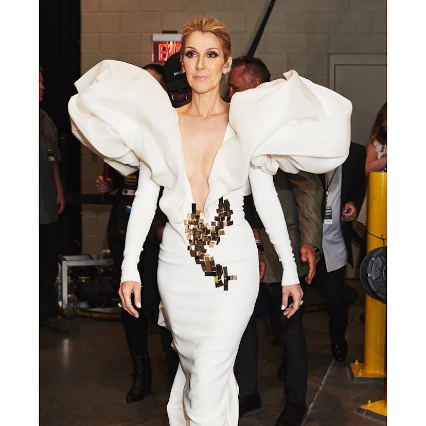 Celine Dion walking in a white gown 