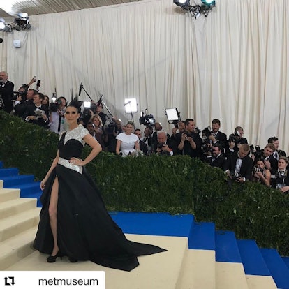 Celine Dion posing for a photo in a black gown