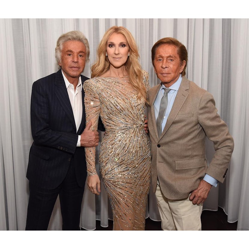 Celine Dion posing in a silver gown with Giancarlo Giammetti and Valentino Garavani