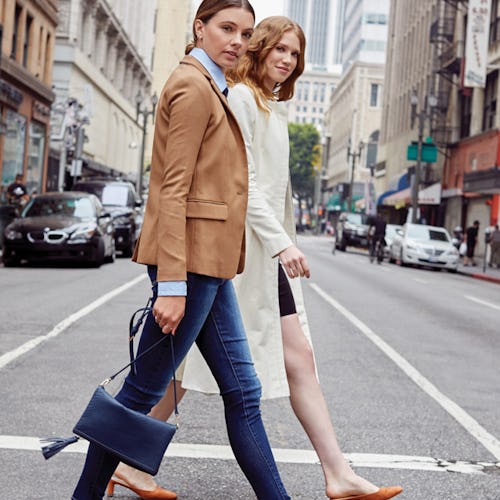 Two women crossing the street in fall clothing