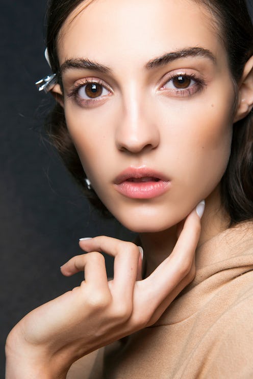 A girl that is using hair, skin, and nail vitamins for beauty routine posing for a photo