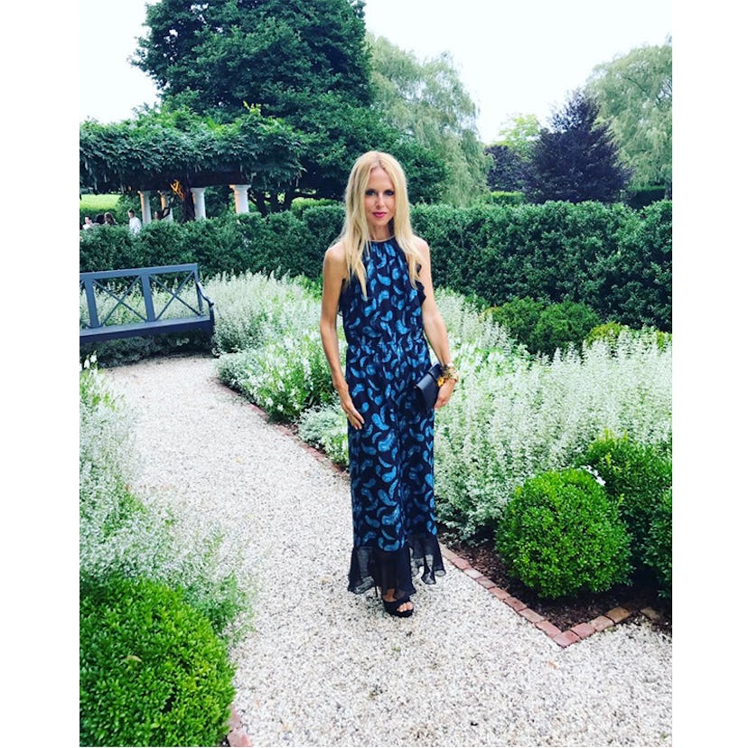 Rachel Zoe wearing Victoria feather printed chiffon maxi dress while standing in a garden