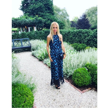 Rachel Zoe wearing Victoria feather printed chiffon maxi dress while standing in a garden