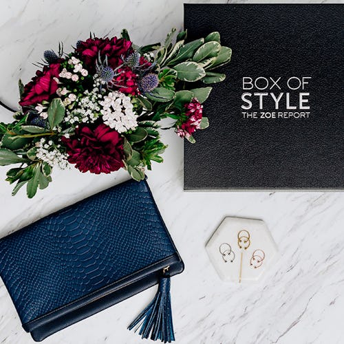 The Fall 2017 Box of Style, blue Convertible Clutch and a bouquet lined up next to each other on a m...