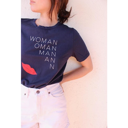 A female posing in a woman tee