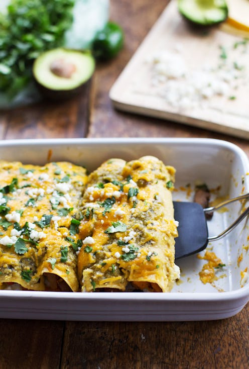 Butternut squash enchiladas served on a plate at a table