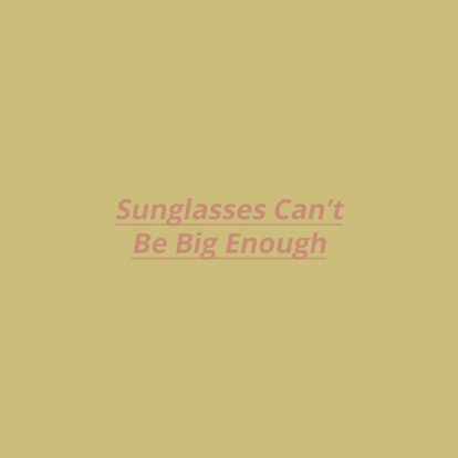 "Sunglasses Can't Be Big Enough" text sign on a yellow background