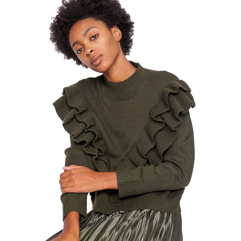 A female model posing for a photo in a nadine knit