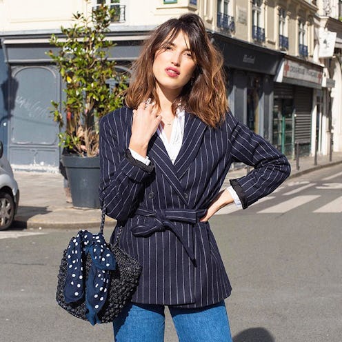 Designer Jeanne Damas posing for a photo in a black blazer jacket