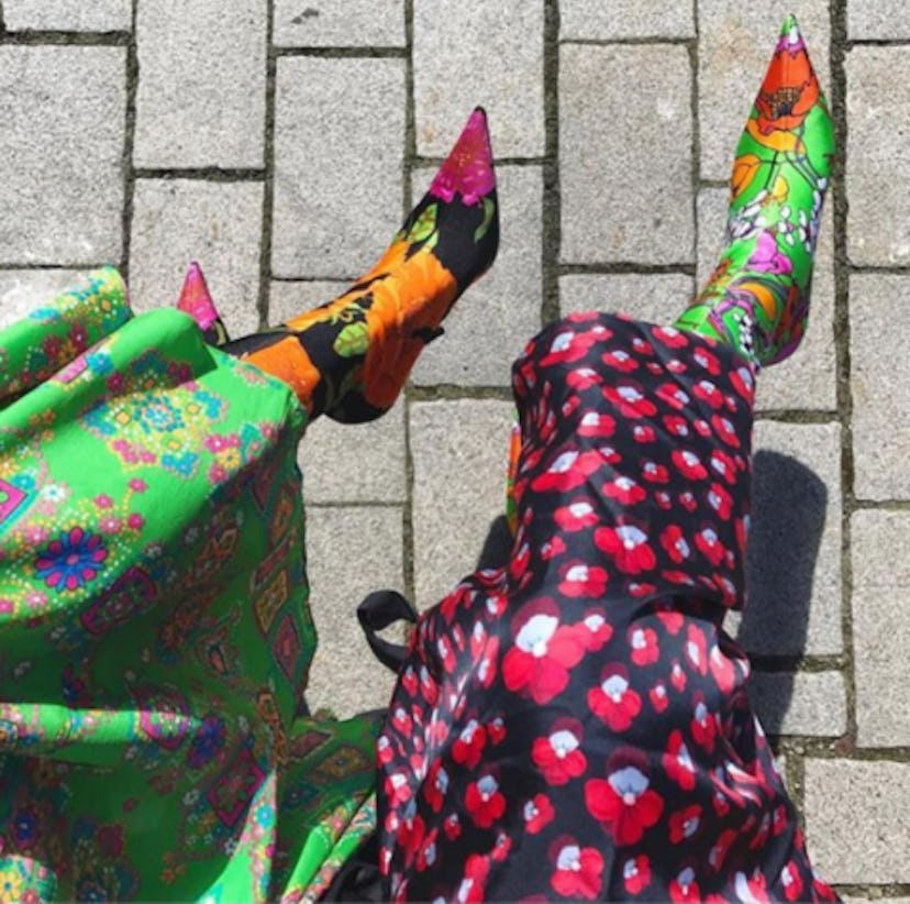 Two women wearing colorful heel boots