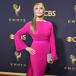 Jane Fonda posing in a long fuchsia gown on the red carpet