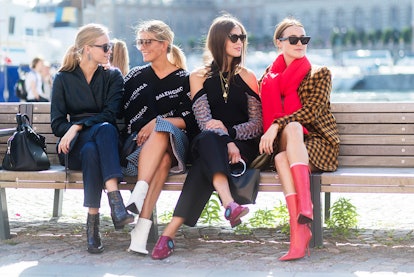 Four Scandinavian It Girls sitting on a public bench 