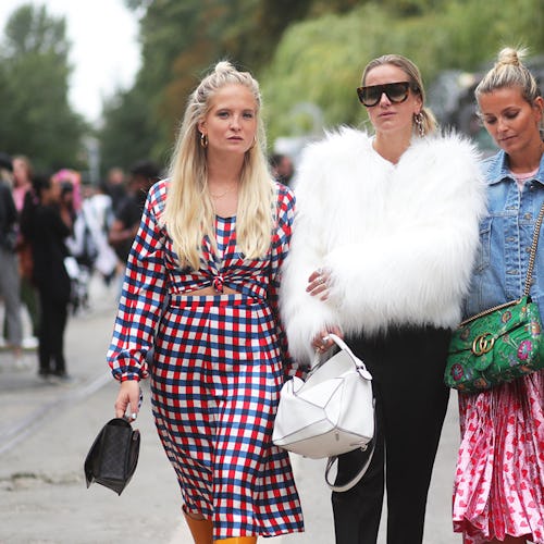 Three Scandinavian It girls walking the street in their fashion outfits