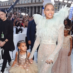 Beyonce in a white feather and sequin dress and Blu Ivy in a rose gold tulle dress