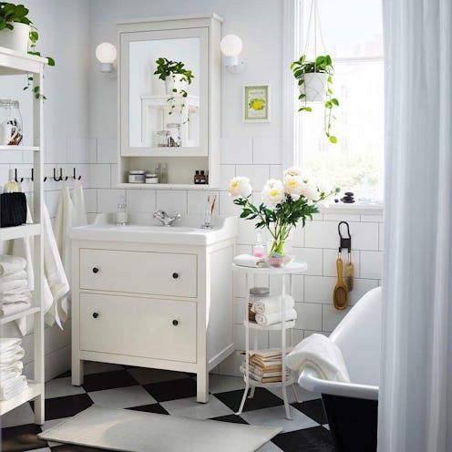A white bathroom equipped with Ikea furniture