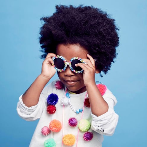 A curly child wearing a celeb-approved cool-kids style