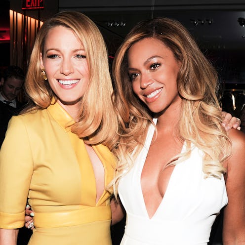 Blake Lively in a yellow dress posing with Beyonce in a white dress with perfect smiles