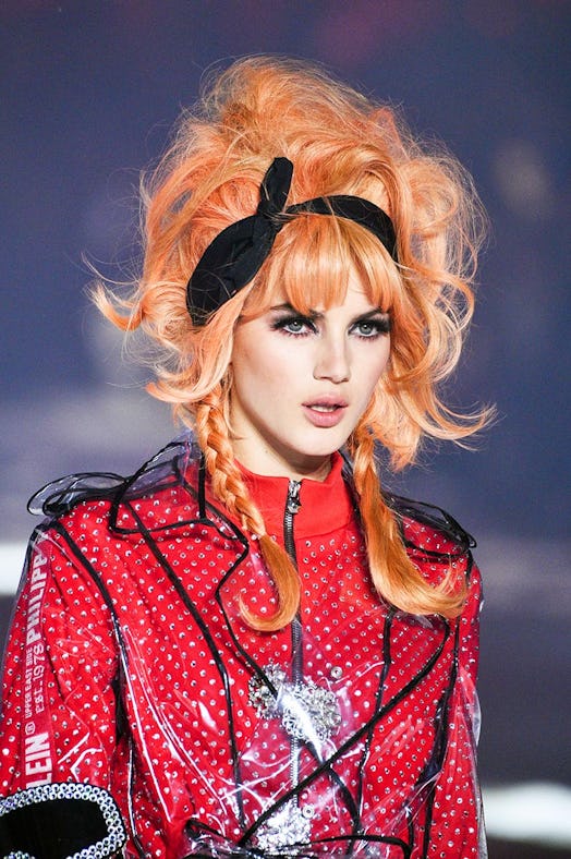 A model with an orange rainbow hairstyle