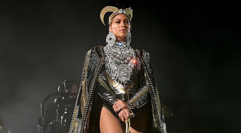 Beyoncé in a sequin and diamond bodysuit, a black-god hat and a black cape at Coachella 2018