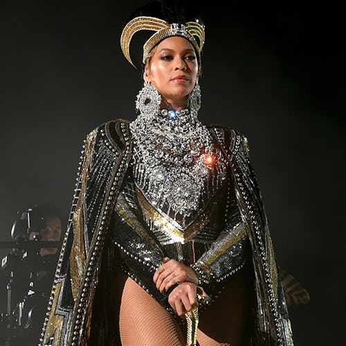 Beyoncé in a sequin and diamond bodysuit, a black-god hat and a black cape at Coachella 2018