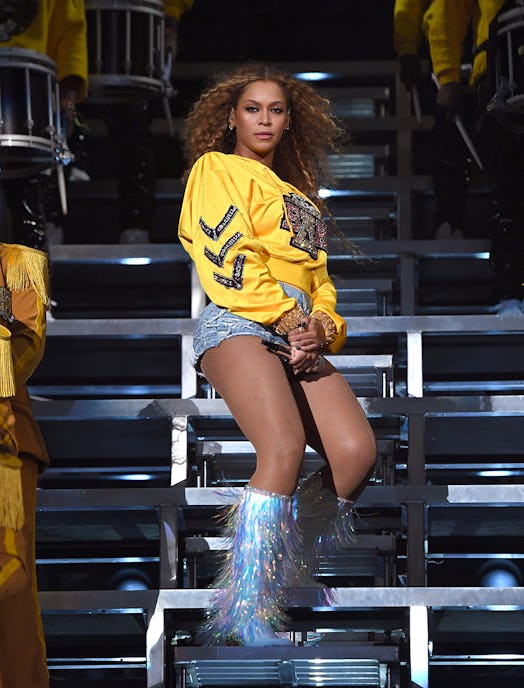 Beyoncé in a yellow sweater on stage