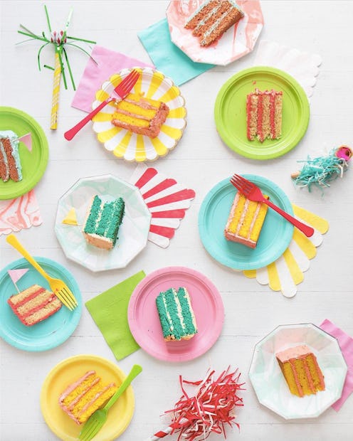 Green, pink and white plates with kids' birthday cakes on them