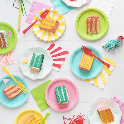 Green, pink and white plates with kids' birthday cakes on them