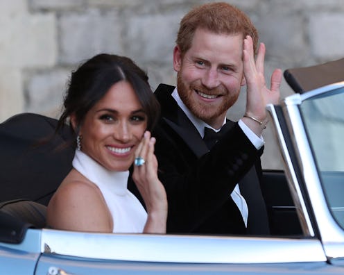 Harry and Meghan waving to people while sitting in a car on their wedding