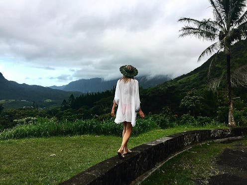 A blonde girl walking in a white cardigan at the Hawaiian Islands