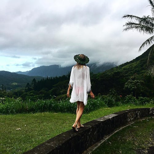 A blonde girl walking in a white cardigan at the Hawaiian Islands