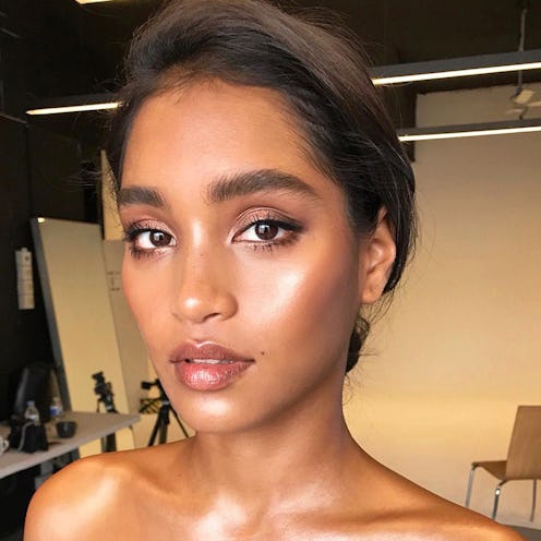 A model with perfect eyebrows taking a selfie