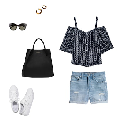 An off shoulder blouse, a black tote, denim shorts, thick tortoise hoops, black sunglasses, and whit...